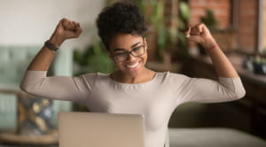 Woman cheering laptop